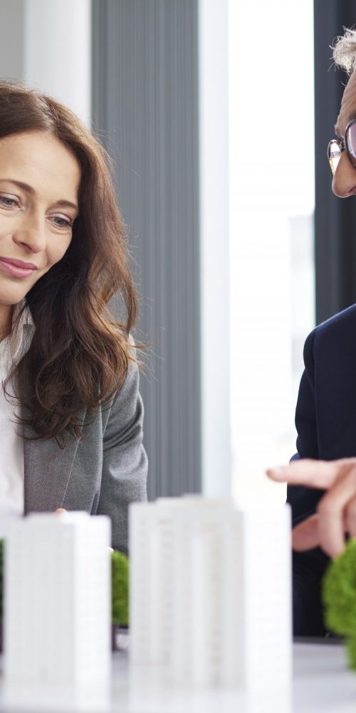 A male coworker gives advice to a female colleague about Royal Bank of Scotland debt consolidation loans